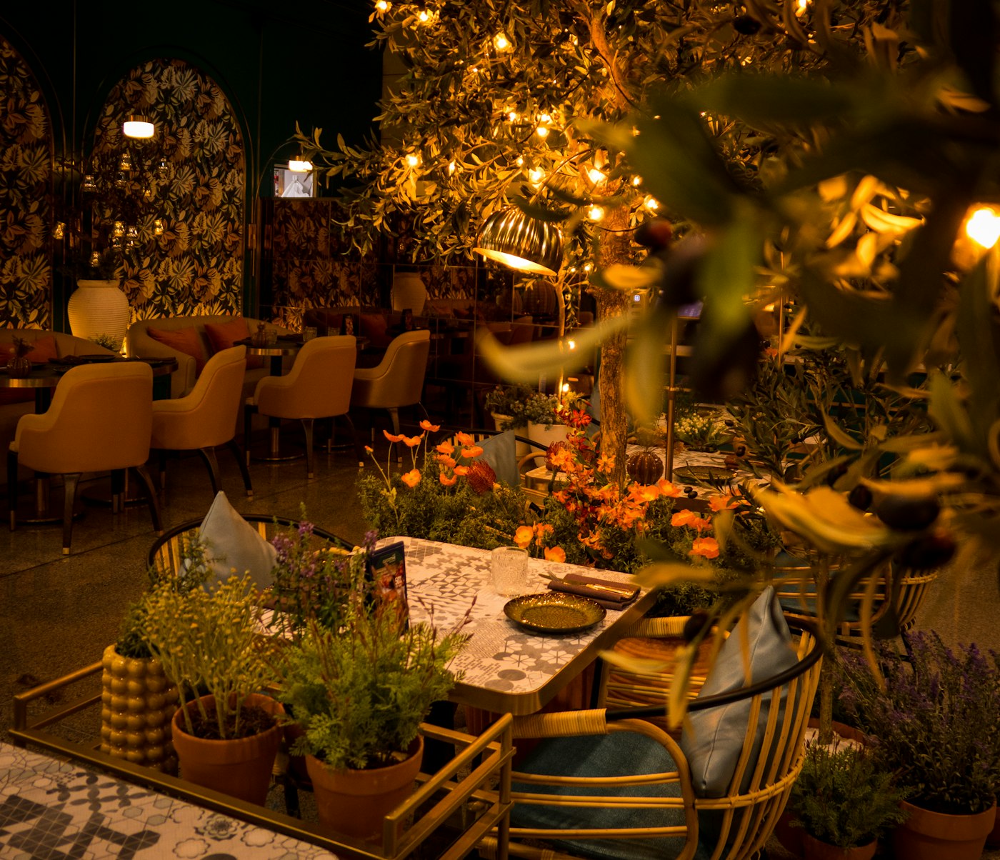 Warm golden lighting and richly detailed restaurant seating